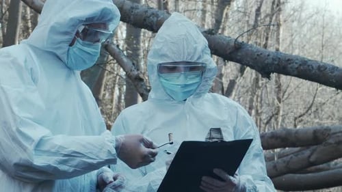 Forensic Specialist Working in the Forest Police Criminalists Collecting Evidence and Making