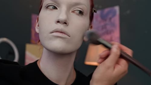 Gen Z Girl Blending White Paint with Makeup Brush after Putting It on Face