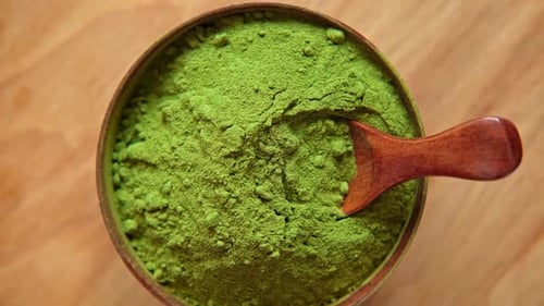 Matcha Powder in Bowl with Wooden Spoon