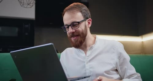 Man Waving During Online Video Conference At Home