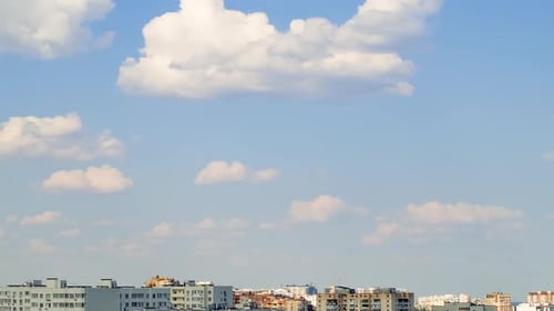 Clouds Run Quickly over City Rooftops
