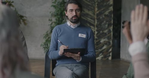 Adults Meet in Group Therapy Session Indoors