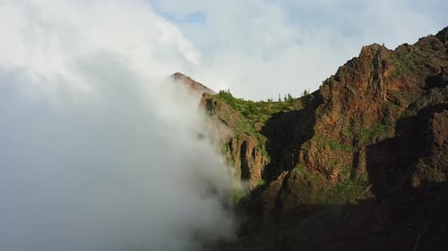 Mountain Peak Surrounded by Clouds Aerial View