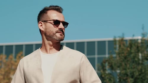 Stylish Man Standing Outdoors on a Sunny Day