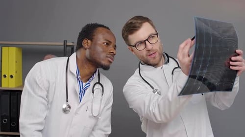 Doctors Examine X-Ray in a Clinic Office