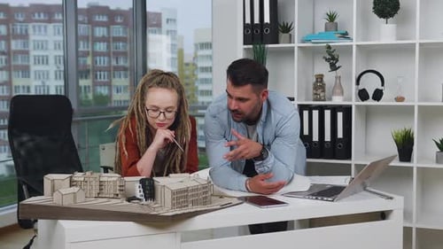 Architects Collaborate on Building Design in Urban Office