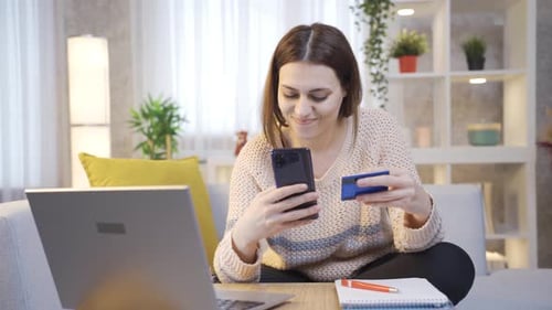 Young Woman Using Laptop Uses Credit Debit Card for Online Shopping Purchases.