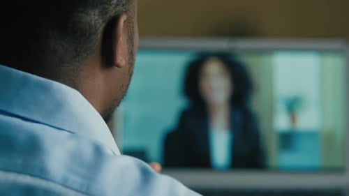 Rear Back View Businessman Man Talk Video Online Meeting with Female Business Partner Use Computer