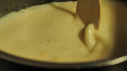 Creamy Liquid Stirred With a Wooden Utensil