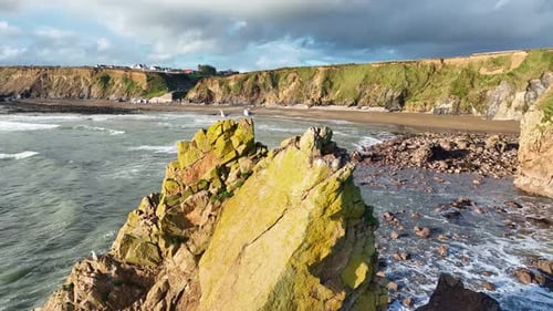 Ireland Epic Locations drone circling sea stack with seagulls and dramatic sea cliffs and beaches