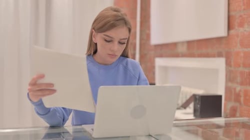 Young Woman Working at Laptop in Office