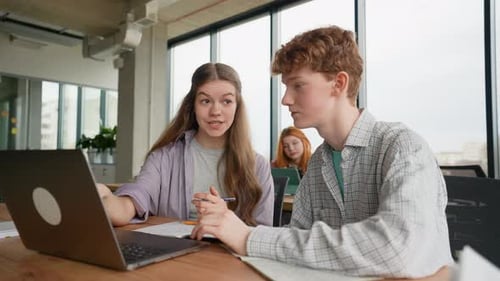University Students in Library Use Laptop Computer for a Research