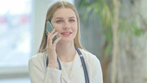 Female Doctor Talking on Phone at Hospital
