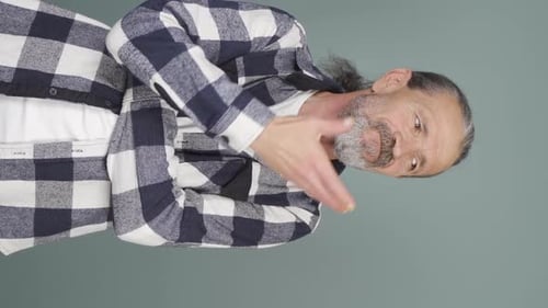 Man in Flannel Shirt Touching His Face