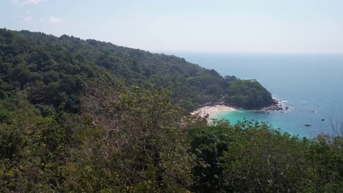 Revealing Drone Shot of Freedom Beach, Tourist Attraction in Tropical Lush of Phuket Island Thailand