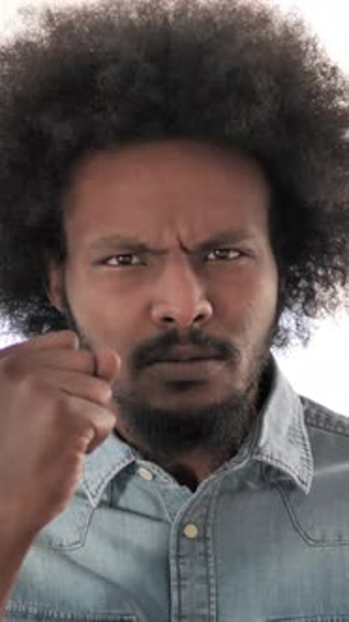 Man Pointing Angrily at the Camera in Studio