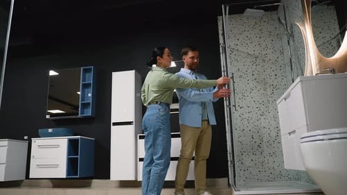 Couple Choosing Shower Enclosure in Bathroom Furniture Store