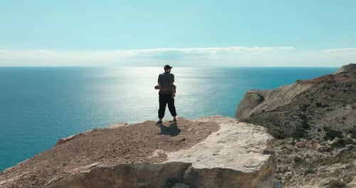 Man Gazing at the Sea From a Cliff on Aphrodite Trail