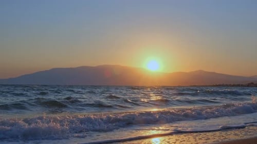 Sunrise on the beach. Sea. Sunlight and sun ray reflect on water surface