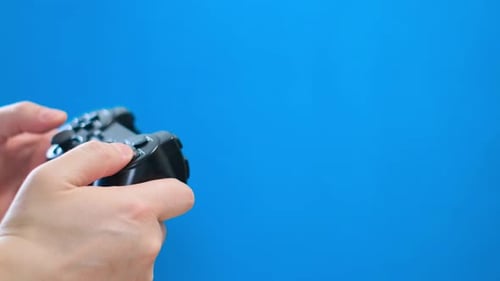Hands Playing a Video Game with Controller