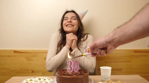 Woman Celebrates 30th Birthday with Cake and Candles