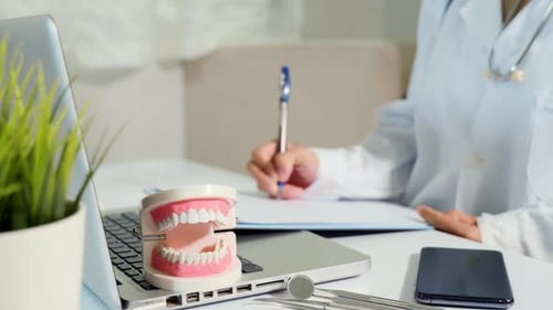 Dentist Taking Notes in Modern Medical Office