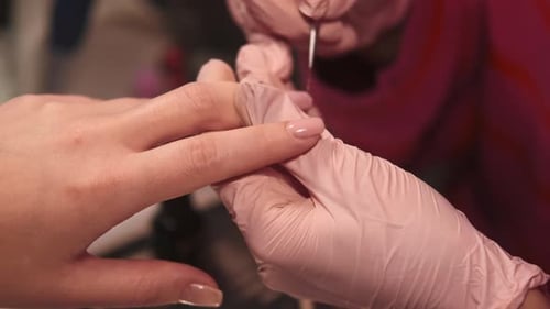 Woman Receiving a Manicure with Pink Gloves