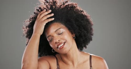 Afro, wind and beauty with black woman in studio for curly hair care, texture and cosmetics