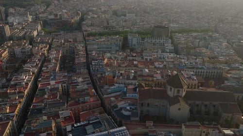 High Angle View of Buildings in Old Town Tilt Up Reveal Metropolis Cityscape at Sunset Barcelona