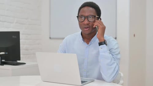 Adult Man On Phone Call in Modern Office