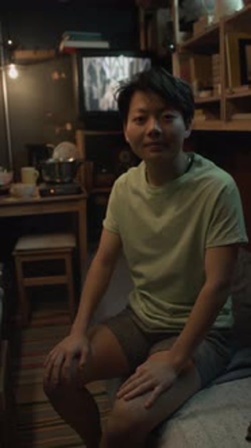 Portrait of Smiling Asian Capsule Flat Dweller at Home