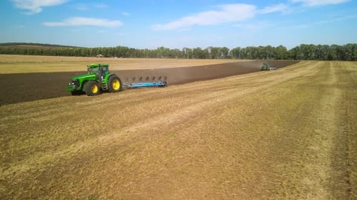 Tractors plowing the field in Ukraine