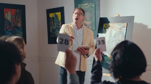 Auctioneer Selling Artwork during Auction in Gallery