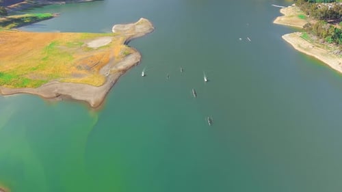 Bird's Eye View Of Rowing Teams Racing On Calm Turquoise Waters Of Lexington Reservoir In California