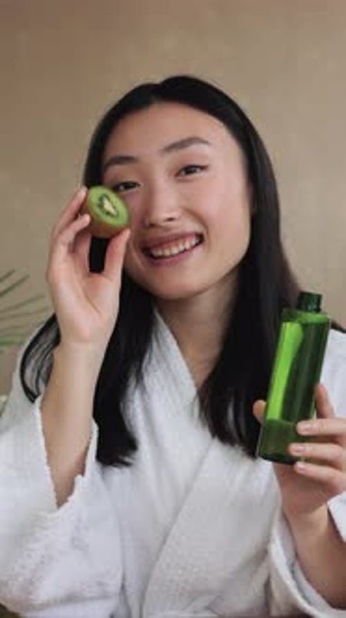 Woman With Kiwi And Green Serum
