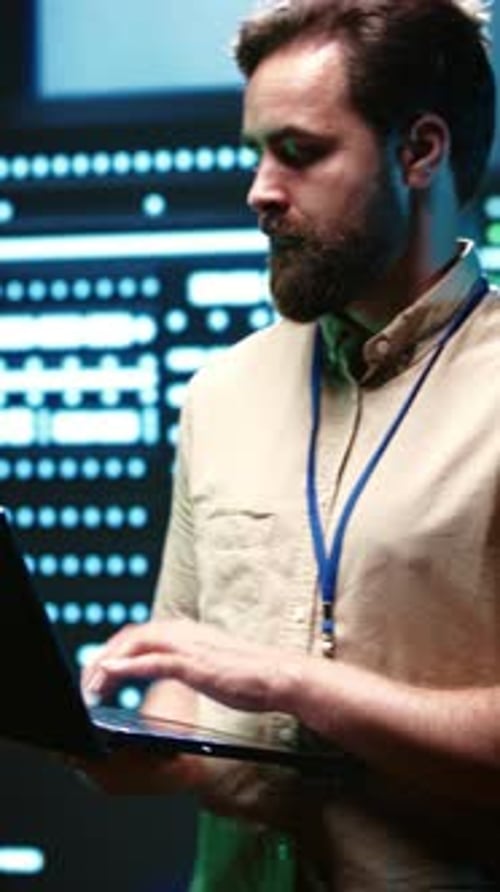 Portrait Format Service Technician Secures Server Room Network Infrastructure