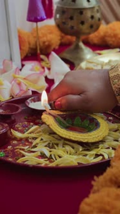 Hand Lighting Ornate Candle for Religious Celebration