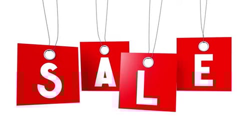 Red Sale Signs Hanging with White Letters