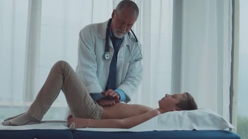 Doctor Examining Young Boy in a Hospital