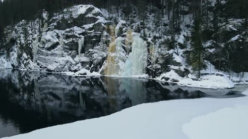 Closing up drone footage of beautiful frozen waterfall in Southern Norway