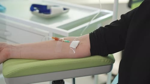 Arm with IV Drip in Hospital Room