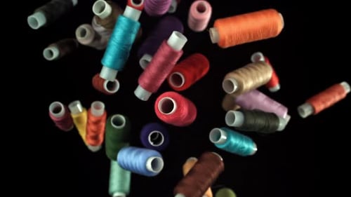 Multicolored Threads Fly on a Black Background Filmed on a Highspeed Camera at 1000 Fps