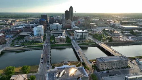 Sunset in Des Moines, Iowa. Aerial establishing shot high above Des Moines River and cityscape.