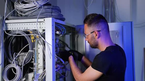 Man Working On Network Server Wiring