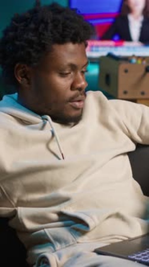 Vertical Video Young Adult Working Remotely From His Loft Apartment on a Laptop