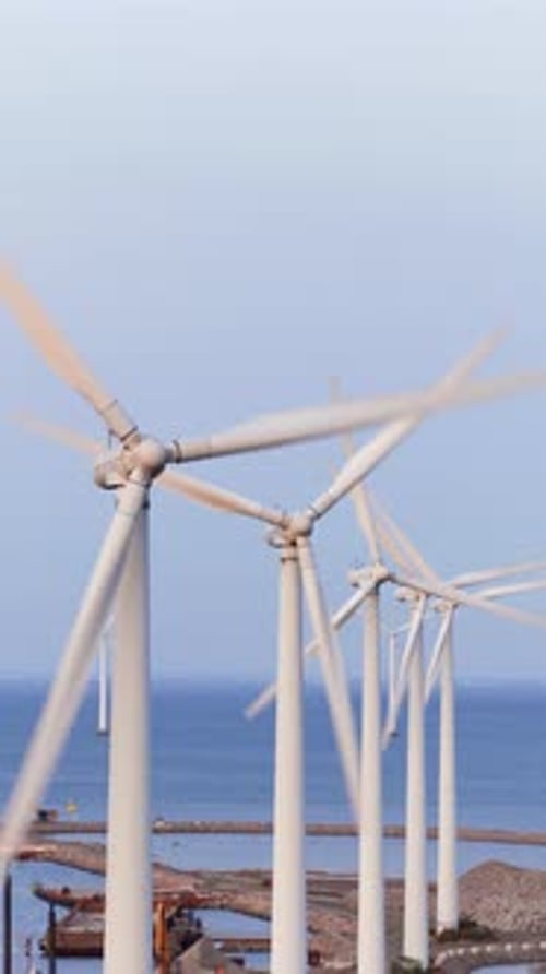 Aerial drone view of offshore wind turbines spinning in the sea at the Oresund Wind Farm in Copenhag