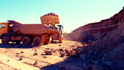Earthmover Filling Dump Truck with Dirt