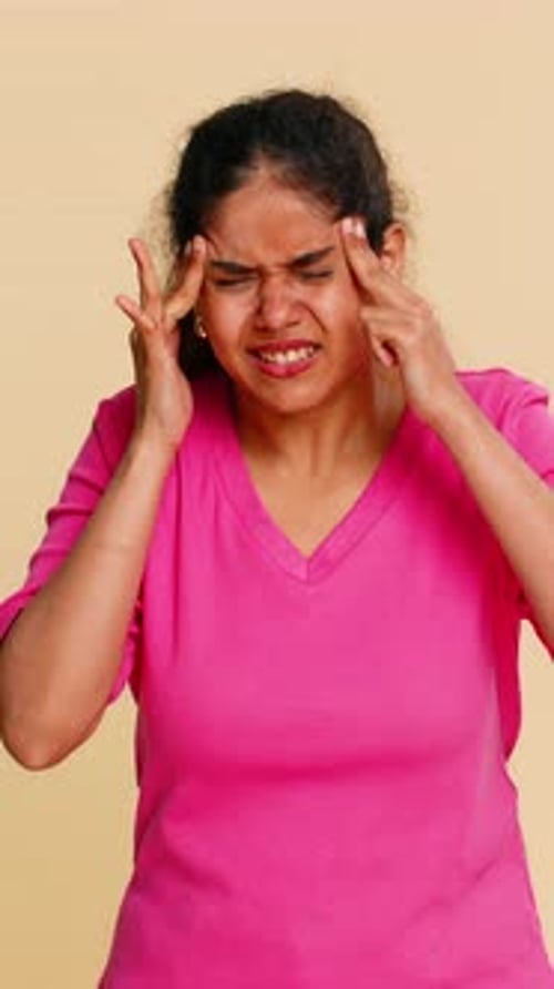 Woman in Pink Shirt Shows Headache Symptoms