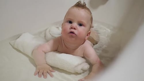 Infant Taking a Bath and Laying on Towel