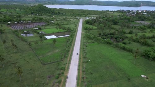Highangle Shot Capturing Vehicle Movement On Vibrant Coast Road